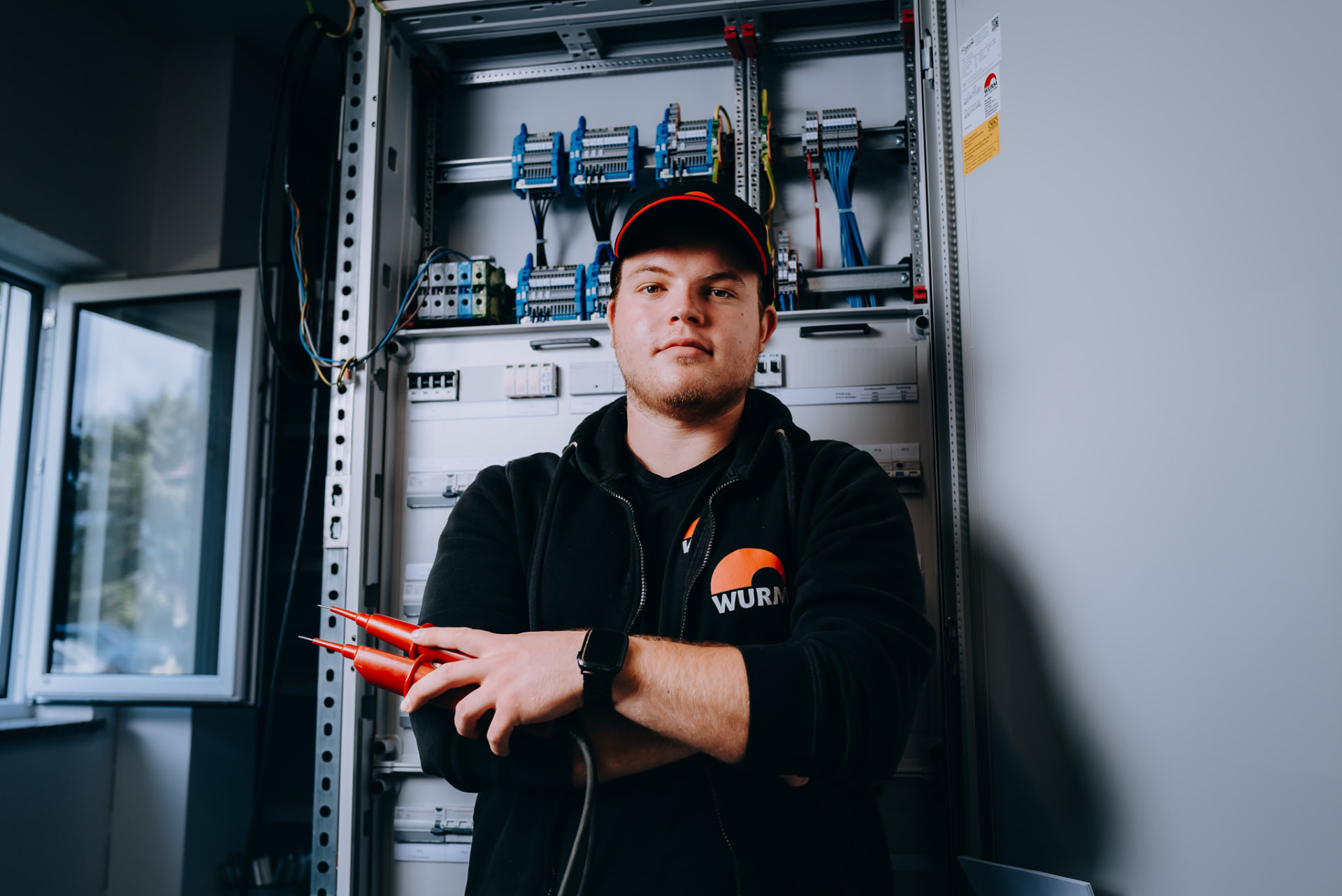Nahes Portrait eines Elektronikers vor der Schaltanlage
